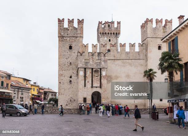 Tourists Walk Around The Piazza Castello In Sirmione Stock Photo - Download Image Now