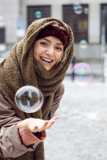 istock Beautiful woman catches bubbles 661488950