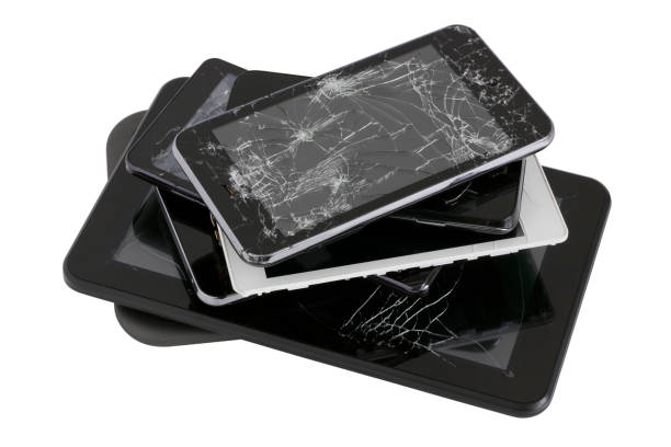 Heap of modern electronic gadgets with the broken screens. Devices are prepared for utilization. Isolated with patch stock photo