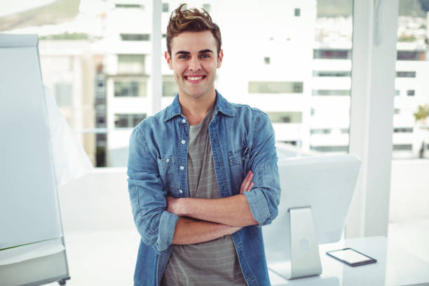 istock Smiling creative businessman by his desk 661504592