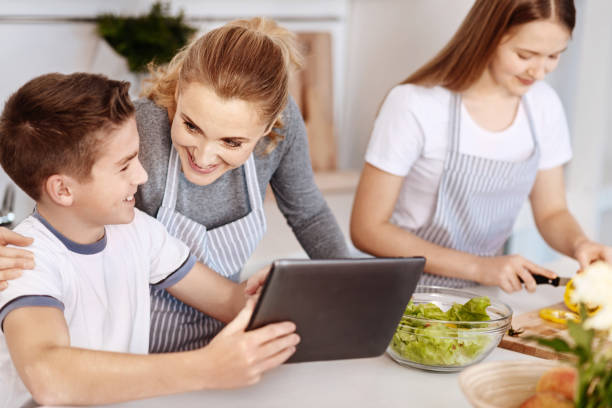 istock Positive delighted family having fun in the kitchen 661505068