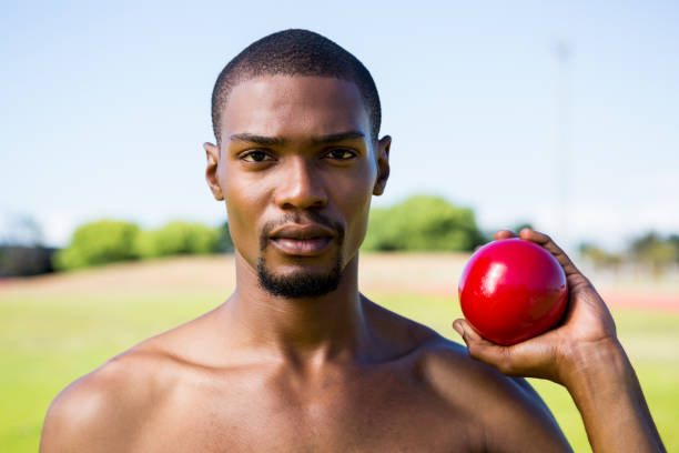 istock Male athlete holding shot put ball 661506288