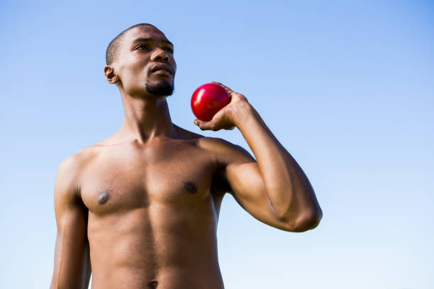 istock Athlete holding shot put ball 661506450