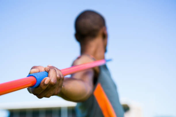 Athlete about to throw a javelin Close-up of athlete about to throw a javelin in the stadium javelin stock pictures, royalty-free photos & images