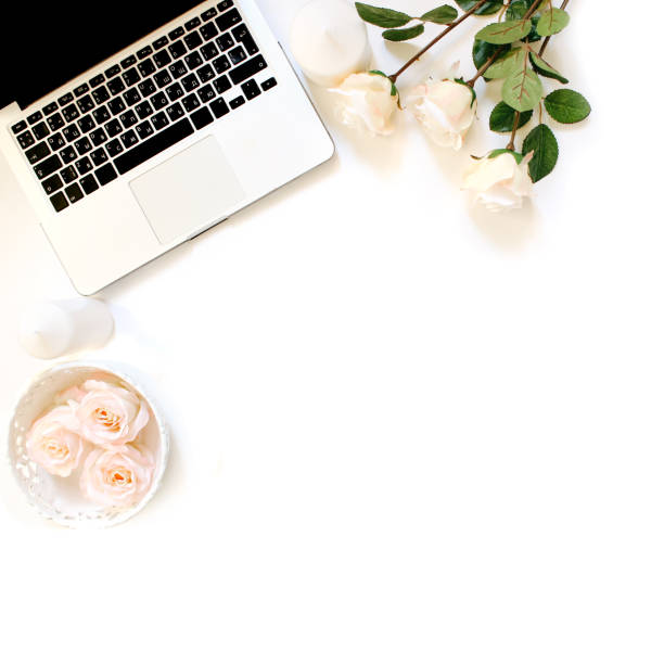 istock Minimalistic workplace with laptop keyboard and roses. Flat lay 661514948