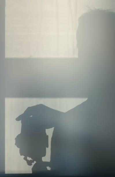 istock Shadow from the photographer on a concrete wall. Light from the window. 661520216