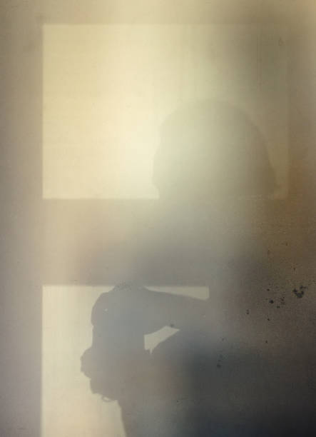 istock Shadow from the photographer on a concrete wall. Light from the window. 661520224