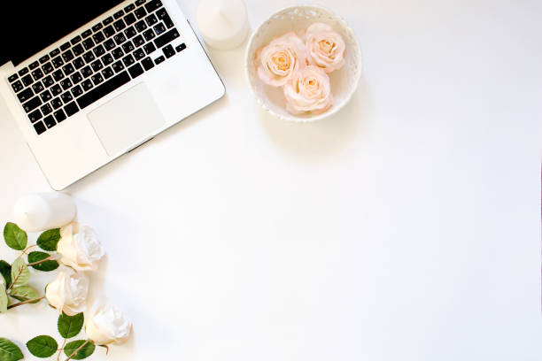 istock Minimalistic workplace with laptop keyboard and roses in flat lay style. White background, top view 661530924