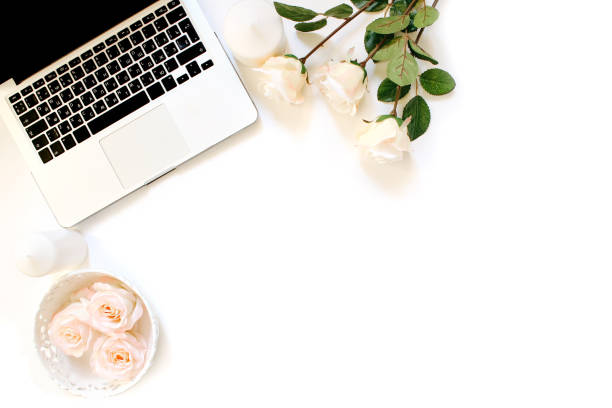 istock Minimalistic workplace with laptop keyboard and roses in flat lay style. White background, top view 661531012