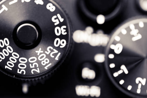 Close up macro image of the shutter speed dial on an old, vintage rangefinder camera. We can also see the bracketing exposure dial. Horizontal toned image with copy space.