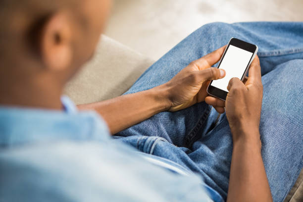 istock Over shoulder view of casual man using smartphone 661537462