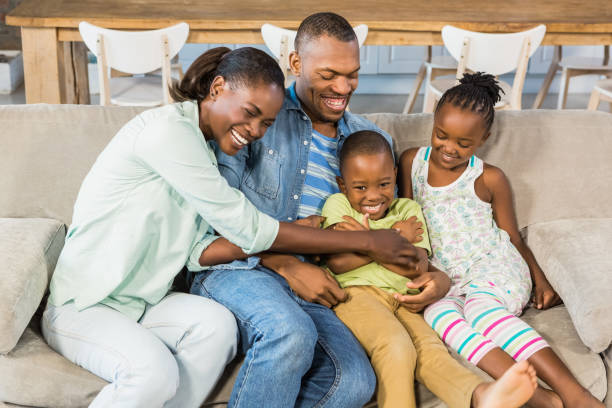 istock Happy family posing on the couch together 661539330
