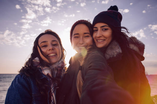istock Young women taking a selfie together at the beach 661545906
