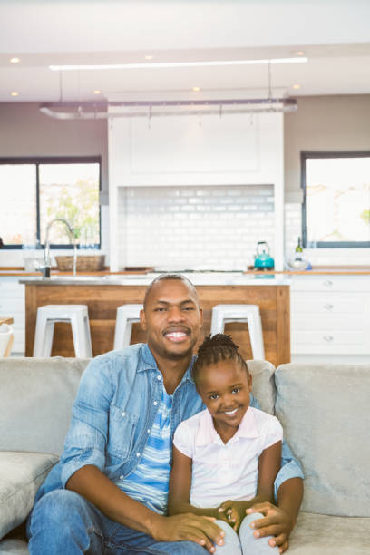 istock Casual father and daughter smiling at camera 661547422