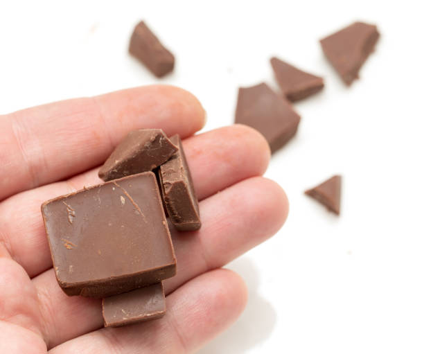 istock chocolate in his hand on a white background 661558508