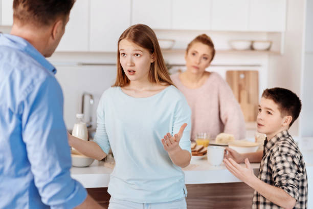 istock Young nervous girl quarrelling with her father 661563294