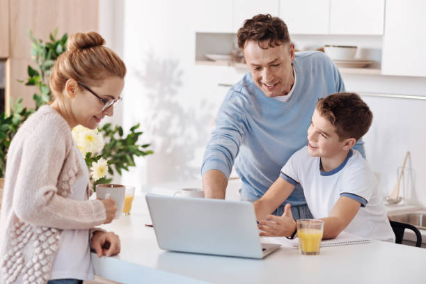 istock Father and son doing homework together in the kitchen 661573644
