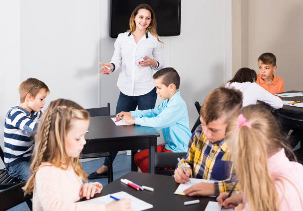 istock Children of elementary age having class of art 661580590