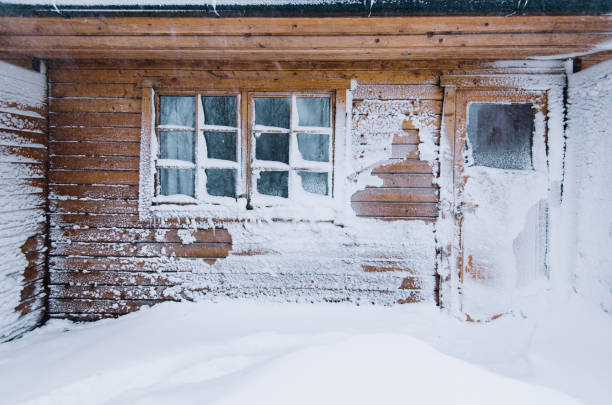 istock Winter wooden house wall covered with snow after blizzard 661600514