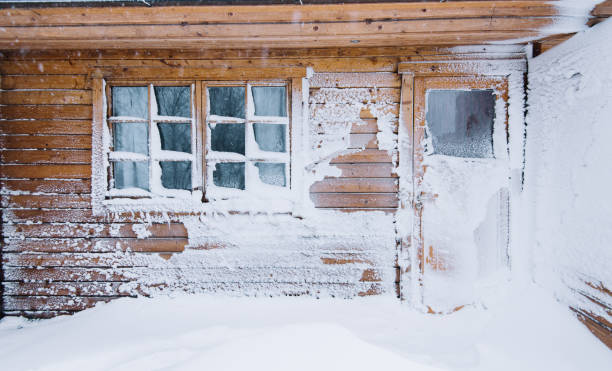 istock Winter wooden house wall covered with snow after blizzard 661600766