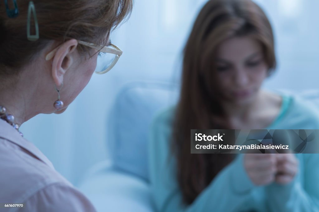 Woman with depression having help Young woman with depression having psychological help Psychiatric Hospital Stock Photo