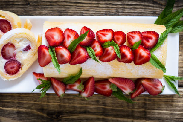 istock Homemade swiss roll biscuit cake with strawberries, top view 661617578