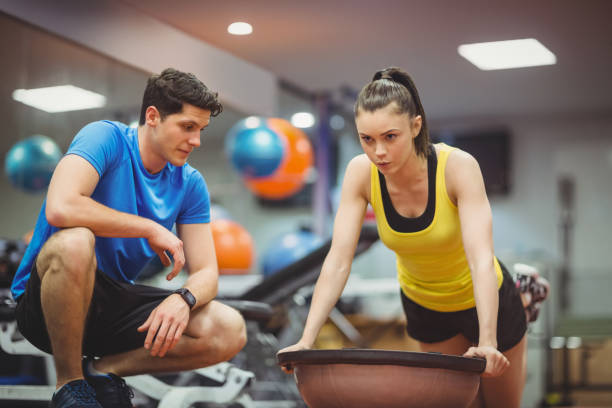 istock Fit woman working out with trainer 661641148