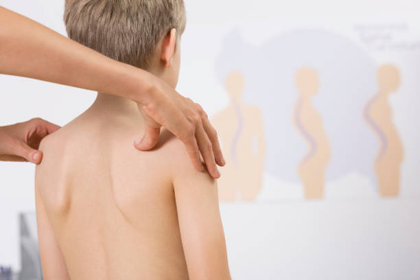 Physiotherapist correcting kids posture Physiotherapist correcting kids faulty posture with her hands good posture stock pictures, royalty-free photos & images