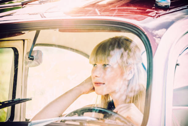 istock Happy Young Woman Driving An Old Fashioned Car 661648772