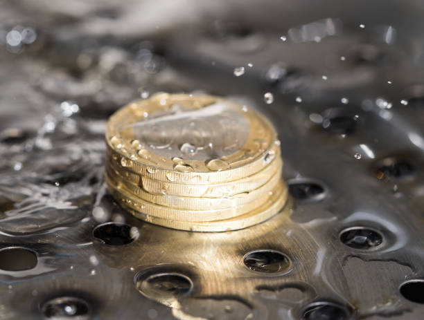 istock coins in a spray of water 661662972