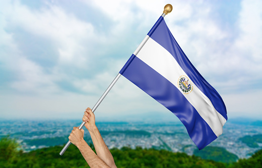 Man holding the national flag of El Salvador high in the air. The flag and pole have been realistically 3D rendered.