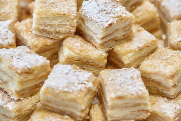 istock Stack of square bakery slices desserts or cakes on plate 661740474