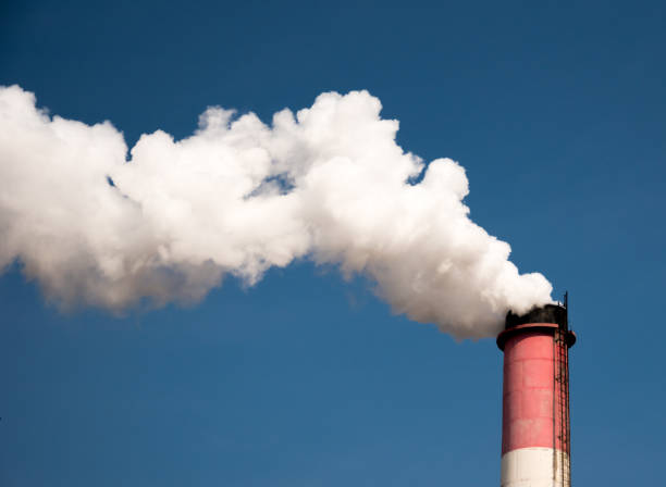 istock white industrial smoke from the chimney on a blue sky 661748284