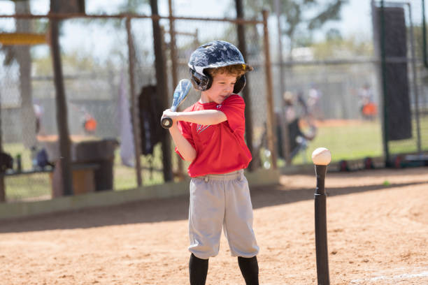 istock Four Year Old Boy Gets Ready to Swing a Baseball Bat at a T-Ball Game 661777300