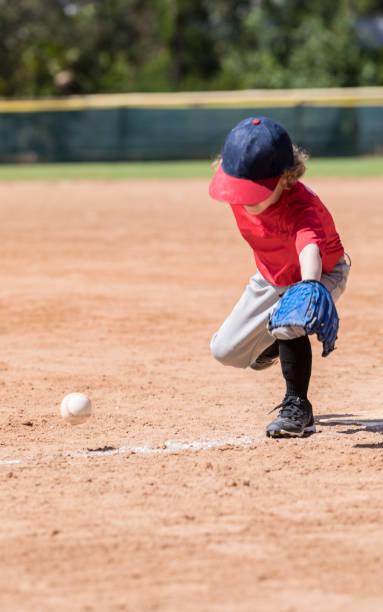 istock Four Year Old Boy Catching a Baseball During a Baseball Game 661777340