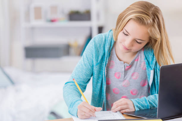 istock Caucasian tween girl studies in her room 661778094