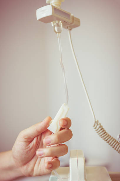 istock Nurse's hands regulation an intravenous (IV) drip in hospital room. 661800000