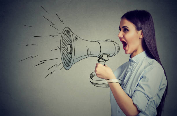 istock Young woman screaming in megaphone 661806226