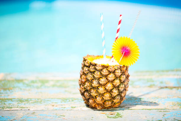 Exotic pineapple cocktail near pool. Pina colada