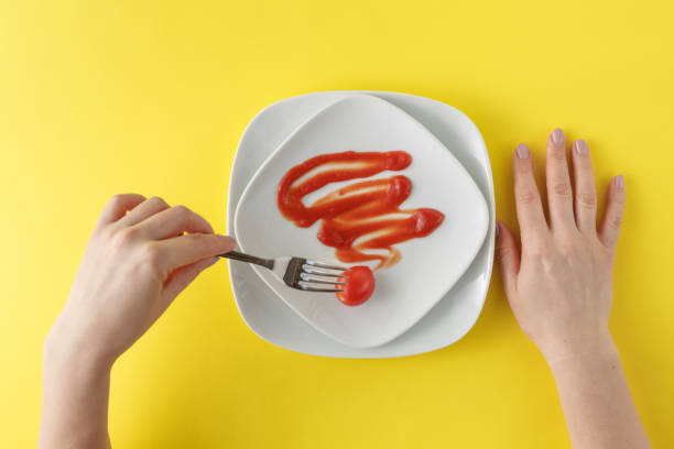 istock ketchup stains on white plate  and hands with fork 661833474