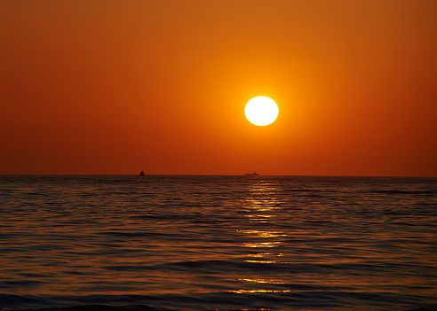 Beautiful sunset over the ocean. Sunrise in the sea. Sun drowned in the sea