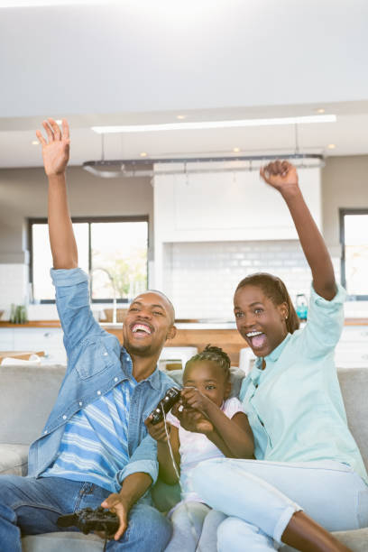 istock Happy family playing video games 661847442