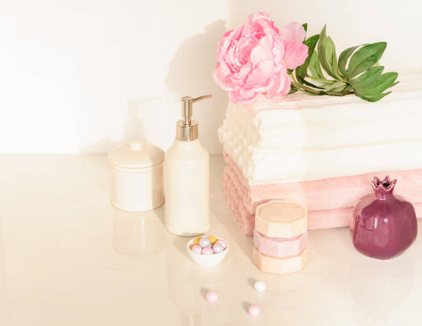 istock Bath settingin white and pink colors. Towel, aroma oil, flowers, soap. Selective focus, horizontal. 661848096