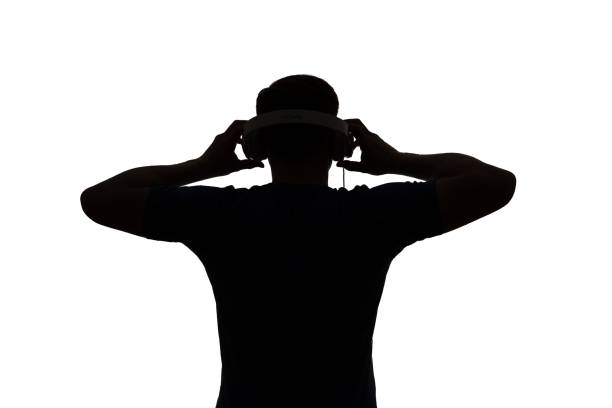 Silhouette of a DJ. He is raising his arms. stock photo
