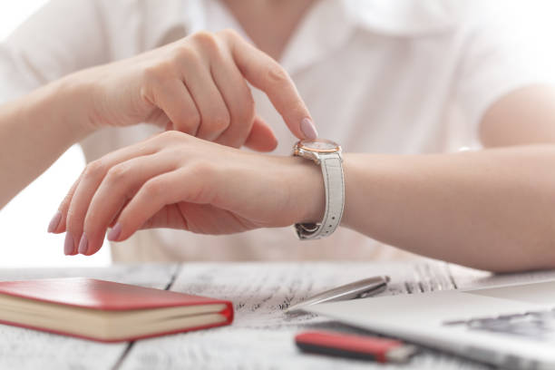 istock business woman with watch at office control time 661853542