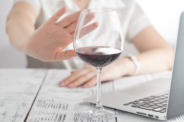 woman refuses to drink a wine woman refuses to drink a wine sobriety stock pictures, royalty-free photos & images