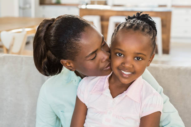 istock Loving mother with daughter on the couch 661865548