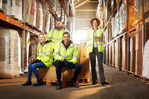 a warehouse team pose for a group shot