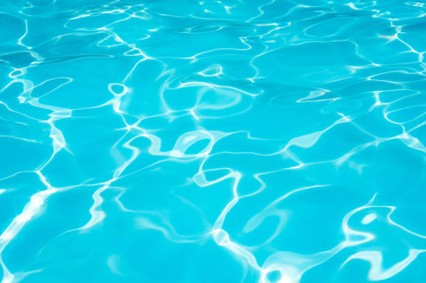 istock Beautiful ripple water surface with sun reflection in swimming pool 661869740