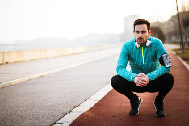 istock Sporty handsome man resting after jogging exercise 661871596